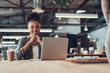 © Yakobchuk Olena - Attractive afro american girl using laptop at office