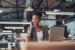 © Yakobchuk Olena - Charming afro american girl with laptop talking on cellphone
