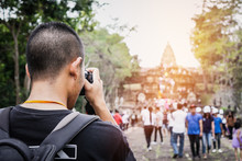 Young Man Asian Photographer Traveler Backpacker Or  Looking Historical Park, Attractions Phanom Rung, An Ancient Khmer Temple Buriram, Thailand. Travel Holiday Lifestyle In Asia Concept. Reae View.