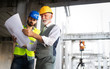© NDABCREATIVITY - Engineer, foreman and worker discussing in building construction site