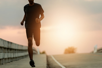 Wall Mural - Athlete runner feet running on road