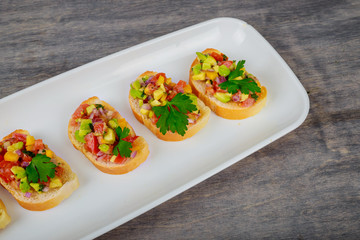 Wall Mural - Tasty sandwich with tomato and avocado vegetables on wooden background