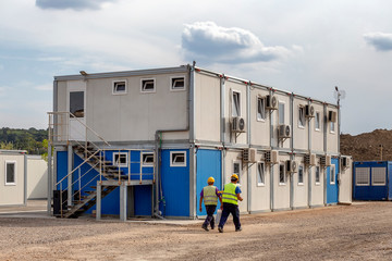 Workers at mobile containers and cabins base