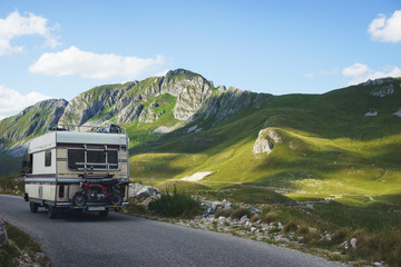 Euro-trip. Old stylish classic motorhome on the road in the mountains. 