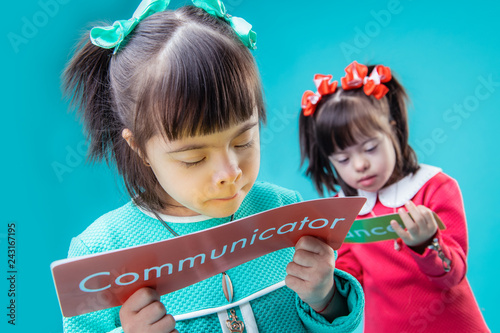 Fotografie, Obraz Dark-haired interested girls holding posters with important messages