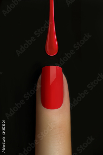 Stampa su Tela Drop of red nail polish dripping on nail isolated on black