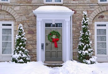 Wall Mural - front door with colorful wreath in winter scene