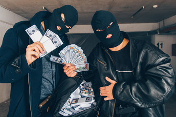 Bandits holding guns and money