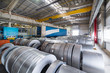 Rolls of sheet metal lie on the floor. Internal warehouse of raw materials