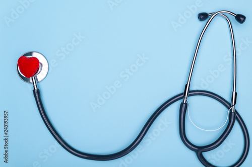 Fotografía Stethoscope and decorative red heart on a blue photo of a doctor in general
