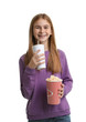 Teenage girl with popcorn and beverage during cinema show on white background
