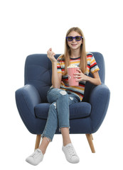 Canvas Print - Teenage girl with 3D glasses and popcorn sitting in armchair during cinema show on white background