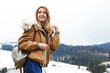 © New Africa - Young woman in warm clothes near snowy hill, space for text. Winter vacation