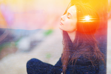 double multiply exposure portrait of a dreamy cute woman meditating outdoors with eyes closed, combi