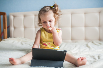 Happy child with tablet computer.