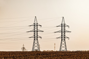 High-voltage towers on the evening sky background.