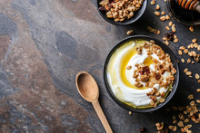 Bowl With Tasty Yogurt, Honey And Oatmeal On Dark Background