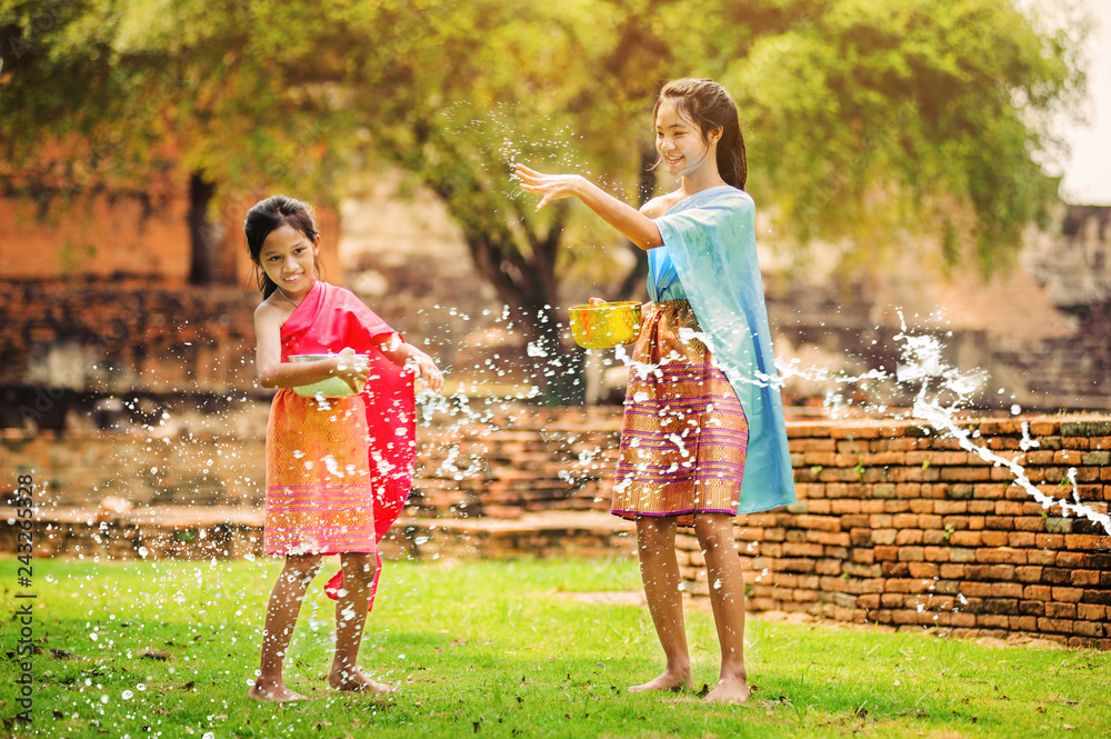 thai girls children playing water in songkran festival with thai period  dress in thailand Stock Photo | Adobe Stock