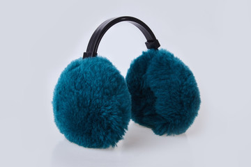 Green furry ear muffs isolated on white