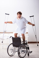 Young handsome man in wheelchair at the hospital 