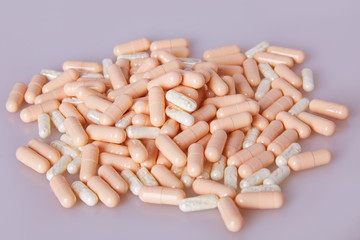 Wall Mural - Spilled white capsules on the white background. Vitamin supplements tablets