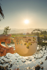 Wall Mural - hot coffee cup with the beautiful nature in rural province