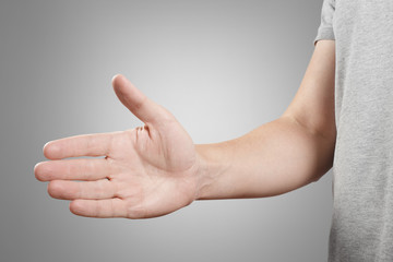 Wall Mural - Greeting male hand, isolated on grey background