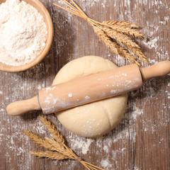 raw dough and rolling pin