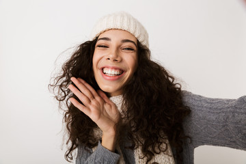 Canvas Print - Cheerful young woman wearing winter scarf standing