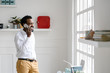 © LStockStudio - Businessman Talking on Cell Phone at Office