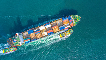 Container ship in export and import business logistics and transportation. Cargo and container box shipping to harbor by crane. Water transport International. Aerial view and top view.