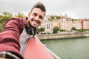 Cheerful man taking a selfie in the city