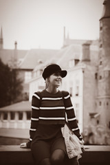 Wall Mural - Young girl red sweater, in hat at streets of Bruges, Belgium. Autumn season Image in sepia color style