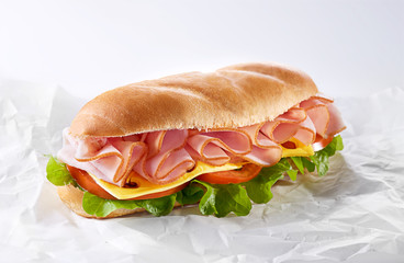 Wall Mural - Salami sandwich made from bun, sliced ham and fresh letttuce, tomato and cheese. Healthy breakfast