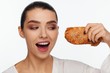 © Andriy Goncharenko - Portrait of a smiling beautiful woman with a sesame bun in her hand