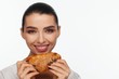 © Andriy Goncharenko - Portrait of a smiling beautiful woman with a sesame bun in her hand