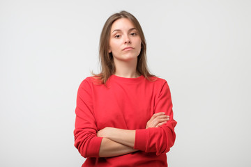 Young serious angry woman portrait on a white background