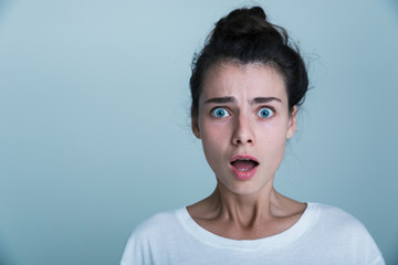 Close up of a shocked young woman wearing tank shirt