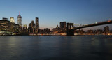 Fototapeta  - View from the sea on the evening of New York and the bridge