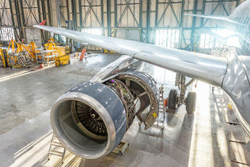 Wall Mural - Opened aircraft engine in the hangar, maintenance. Wing view