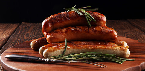 Wall Mural - Grilled sausages with spices on a wooden table - Home-made Pork Sausages