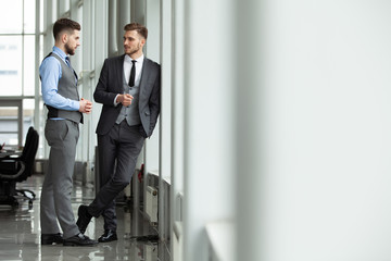 Two business colleagues at meeting in modern office interior.