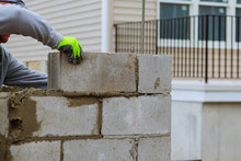 Masonry Worker Make Concrete Wall By Cement Block And Plaster At Construction Site