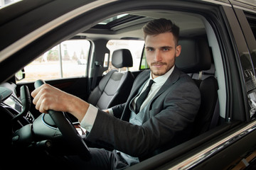 Young business man test drive new car.