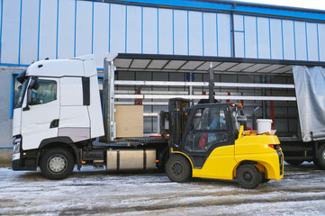 Unloading goods from a truck with a forklift. Transport.