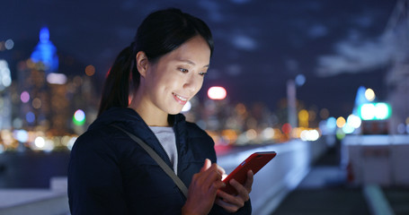 Wall Mural - Woman check on cellphone at night