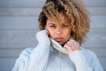 Close up beautiful young african american woman in warm sweater