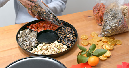 Poster - Woman fill with chinese new year snack tray