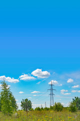 Wall Mural - Template with a high-voltage power line in a field against a blue sky with an empty place for text