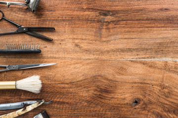 Old vintage barbershop tools on wooden table - barbershop background with copy-space